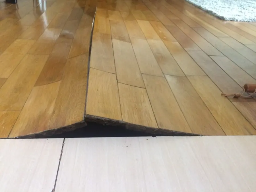 Hardwood floor boards buckled upward after soaking up water